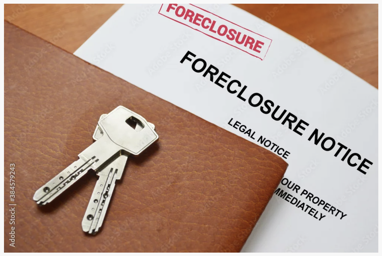 Foreclosure notice beside house keys